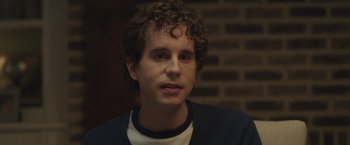 Movie still from “Dear Evan Hansen” (2021), directed by Stephen Chbosky – A man with curly brown hair is looking at the camera; Close Up shot, Over the shoulder angle