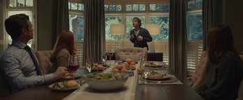 Movie still from “Dear Evan Hansen” (2021), directed by Stephen Chbosky – A group of people sitting around a table with plates of food on top of it; Medium shot, Over the shoulder angle