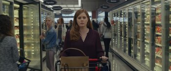 Movie still from “Dear Evan Hansen” (2021), directed by Stephen Chbosky – A woman pushing a shopping cart in a grocery store; Medium shot, Over the shoulder angle
