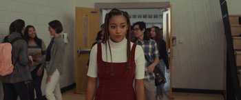 Movie still from “Dear Evan Hansen” (2021), directed by Stephen Chbosky – A woman with braids standing in front of a group of people; Medium shot, Over the shoulder angle