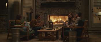 Movie still from “Dear Evan Hansen” (2021), directed by Stephen Chbosky – Two people sitting in front of a fire place; Wide shot, Over the shoulder angle