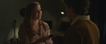 Movie still from “Dear Evan Hansen” (2021), directed by Stephen Chbosky – A man and a woman are holding a remote control; Medium shot, Over the shoulder angle