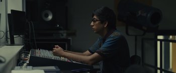 Movie still from “Dear Evan Hansen” (2021), directed by Stephen Chbosky – A man sitting in front of a computer keyboard; Medium shot, High angle