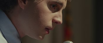 Movie still from “Dear Evan Hansen” (2021), directed by Stephen Chbosky – A person with a microphone; Extreme Close Up shot, Low angle
