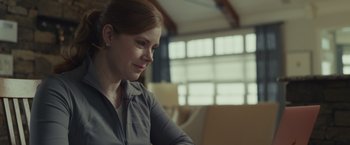 Movie still from “Dear Evan Hansen” (2021), directed by Stephen Chbosky – A woman sitting at a table in front of a window; Close Up shot, Over the shoulder angle