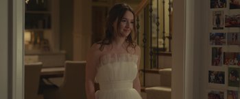 Movie still from “Dear Evan Hansen” (2021), directed by Stephen Chbosky – A woman in a white dress standing next to a staircase; Medium shot, Over the shoulder angle