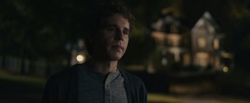 Movie still from “Dear Evan Hansen” (2021), directed by Stephen Chbosky – A young man standing in the dark outside at night; Close Up shot, Over the shoulder angle