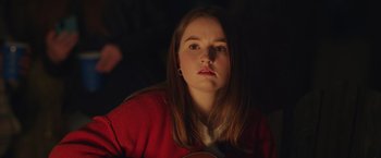 Movie still from “Dear Evan Hansen” (2021), directed by Stephen Chbosky – A woman with a guitar in a dark room; Close Up shot, Over the shoulder angle