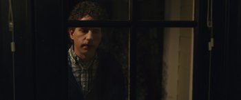 Movie still from “Dear Evan Hansen” (2021), directed by Stephen Chbosky – A man looking out of a window at night; Close Up shot, Over the shoulder angle