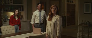 Movie still from “Dear Evan Hansen” (2021), directed by Stephen Chbosky – A man and a woman standing next to each other in front of a laptop computer; Medium shot, Over the shoulder angle