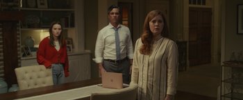 Movie still from “Dear Evan Hansen” (2021), directed by Stephen Chbosky – A man and a woman standing in front of an open laptop; Medium shot, Over the shoulder angle