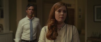 Movie still from “Dear Evan Hansen” (2021), directed by Stephen Chbosky – A woman with long red hair standing next to a man; Medium shot, Over the shoulder angle