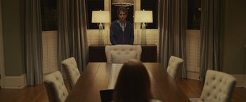 Movie still from “Dear Evan Hansen” (2021), directed by Stephen Chbosky – A man standing in front of a woman at a dining room table; Medium shot, Over the shoulder angle