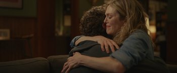 Movie still from “Dear Evan Hansen” (2021), directed by Stephen Chbosky – A woman hugging a man on a couch in a living room; Close Up shot, Over the shoulder angle