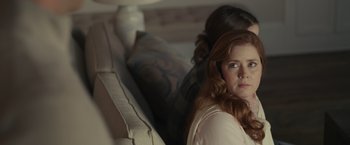 Movie still from “Dear Evan Hansen” (2021), directed by Stephen Chbosky – A woman sitting next to another woman on a couch; Close Up shot, Over the shoulder angle