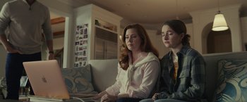 Movie still from “Dear Evan Hansen” (2021), directed by Stephen Chbosky – Two young women sitting on a couch in a living room; Medium shot, Over the shoulder angle