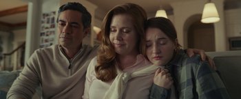 Movie still from “Dear Evan Hansen” (2021), directed by Stephen Chbosky – A woman with her hands on her shoulders and a man with her hands on her shoulder; Medium shot, Over the shoulder angle