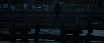 Movie still from “Two Lovers” (2008), directed by James Gray – A man riding a skate board on top of a wooden rail; Extreme Wide shot, High angle