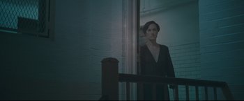 Movie still from “Two Lovers” (2008), directed by James Gray – A woman standing in front of an open window; Medium shot, Over the shoulder angle