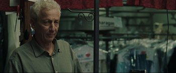 Movie still from “Two Lovers” (2008), directed by James Gray – An older man standing next to a pole; Close Up shot, Over the shoulder angle