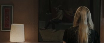 Movie still from “Two Lovers” (2008), directed by James Gray – A man sitting on the ground in front of a mirror; Medium shot, Over the shoulder angle