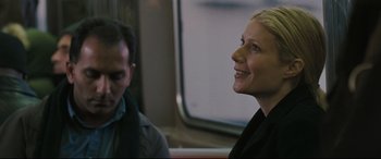 Movie still from “Two Lovers” (2008), directed by James Gray – A woman smiles as she rides on a train; Close Up shot, Over the shoulder angle