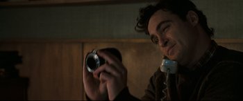Movie still from “Two Lovers” (2008), directed by James Gray – A man taking a picture of himself with a camera; Close Up shot, Low angle