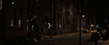 Movie still from “Two Lovers” (2008), directed by James Gray – A person walking down a street at night; Extreme Wide shot, High angle