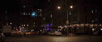 Movie still from “Two Lovers” (2008), directed by James Gray – A white limousine parked on the side of the road; Extreme Wide shot, Over the shoulder angle