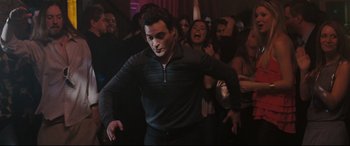 Movie still from “Two Lovers” (2008), directed by James Gray – A group of people dancing in a room; Medium shot, Low angle