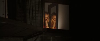 Movie still from “Two Lovers” (2008), directed by James Gray – A woman looking at herself in a mirror; Medium shot, High angle