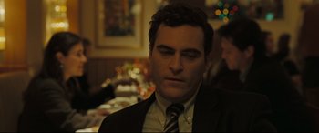 Movie still from “Two Lovers” (2008), directed by James Gray – A person wearing a suit and tie; Close Up shot, Over the shoulder angle
