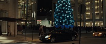 Movie still from “Two Lovers” (2008), directed by James Gray – A car is parked in front of a christmas tree; Extreme Wide shot, Low angle