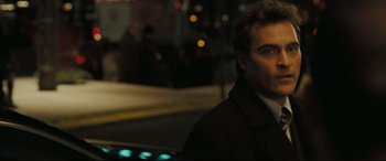 Movie still from “Two Lovers” (2008), directed by James Gray – A man in a black jacket standing next to a car; Close Up shot, Over the shoulder angle
