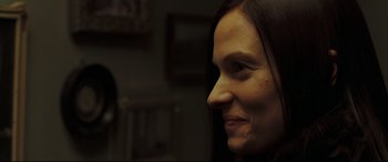 Movie still from “Two Lovers” (2008), directed by James Gray – A woman's face in a dark room; Close Up shot, Over the shoulder angle