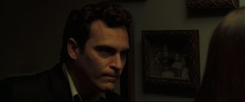 Movie still from “Two Lovers” (2008), directed by James Gray – A person in a room with a picture on the wall; Close Up shot, Over the shoulder angle