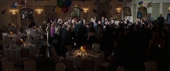 Movie still from “Two Lovers” (2008), directed by James Gray – A group of people standing around a table; Extreme Wide shot, High angle