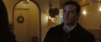 Movie still from “Two Lovers” (2008), directed by James Gray – A man standing in front of a mirror in a room; Close Up shot, Over the shoulder angle