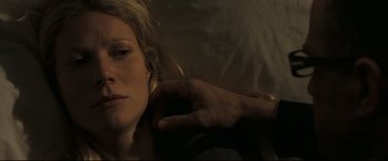 Movie still from “Two Lovers” (2008), directed by James Gray – A woman laying on a bed with a hand touching her ear; Close Up shot, Overhead angle