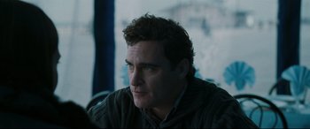 Movie still from “Two Lovers” (2008), directed by James Gray – A person sitting in a room; Close Up shot, Over the shoulder angle