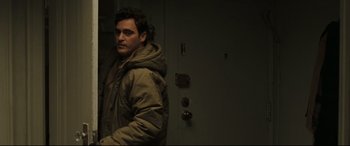 Movie still from “Two Lovers” (2008), directed by James Gray – A man standing in front of an open door; Medium shot, Over the shoulder angle