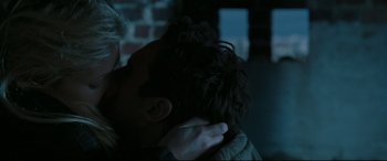 Movie still from “Two Lovers” (2008), directed by James Gray – A woman is holding a man's face in a dark room; Close Up shot, Over the shoulder angle