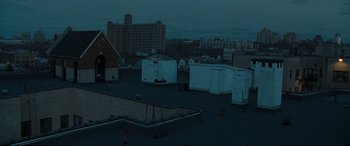 Movie still from “Two Lovers” (2008), directed by James Gray – A view of a city rooftops at night time; Extreme Wide shot, High angle