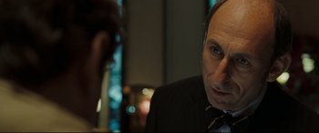Movie still from “Two Lovers” (2008), directed by James Gray – A person wearing a suit and tie; Close Up shot, Over the shoulder angle