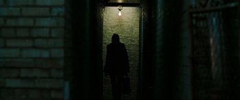 Movie still from “Two Lovers” (2008), directed by James Gray – A woman is walking down a dark alley way; Wide shot, Low angle