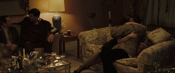 Movie still from “Two Lovers” (2008), directed by James Gray – Two people sitting on couches in a living room; Wide shot, Over the shoulder angle