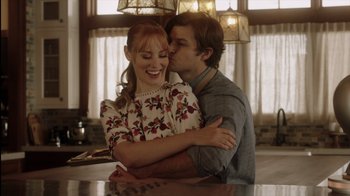 Movie still from “Deborah” (2022), directed by Noga Pnueli – A man and a woman embracing in a kitchen; Medium shot, Low angle
