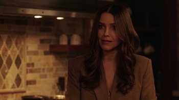 Movie still from “Deborah” (2022), directed by Noga Pnueli – A beautiful woman with long brown hair wearing a brown jacket; Close Up shot, Over the shoulder angle