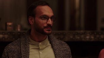 Movie still from “Deborah” (2022), directed by Noga Pnueli – A man with a beard and glasses is looking at the camera; Close Up shot, Over the shoulder angle