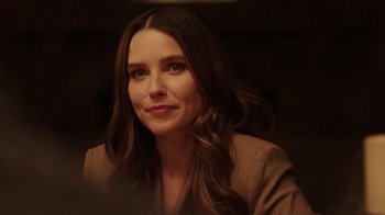 Movie still from “Deborah” (2022), directed by Noga Pnueli – A woman with long brown hair sitting in a room; Close Up shot, Over the shoulder angle